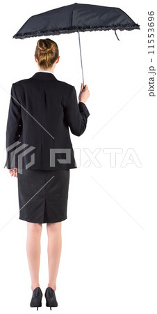 Businesswoman holding a black umbrella 11553696