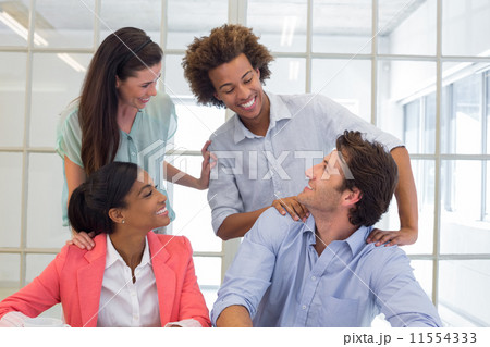 Workers congratulating and praising one another Workers congratulating and praising one another 11554333