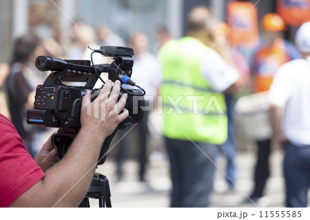 Filming an event with a video camera   11555585