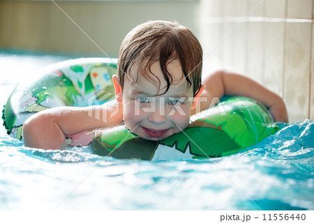 Young boy in inflatable tube swimming 11556440