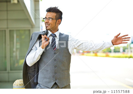 Young businessman hailing for a taxi on the street Young businessman hailing for a taxi on the street 11557588