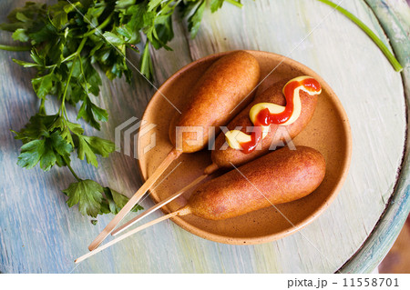 corndog with mustard, ketchup and parsley corndog with mustard, ketchup and parsley 11558701
