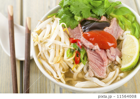 Pho Bo - Vietnamese rice noodle soup with beef, herbs and chili Pho Bo - Vietnamese rice noodle soup with beef, herbs and chili 11564008