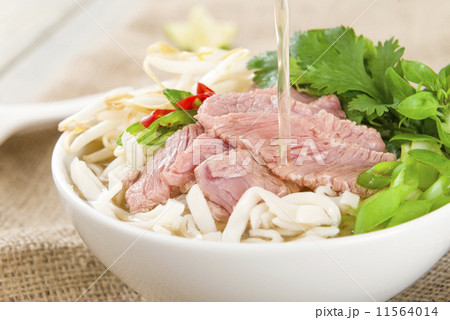 Pho Bo - Vietnamese rice noodle soup with beef, herbs and chili  11564014