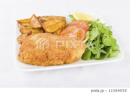 Wiener Schnitzel - Breaded fried veal, potato wedges and salad.  11564050