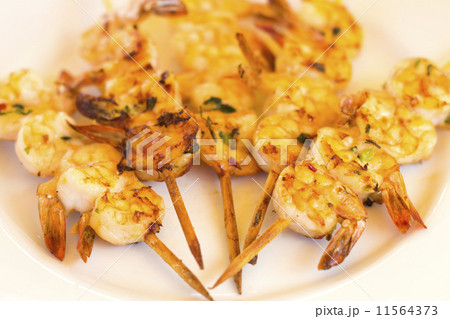 BBQ Prawns - Grilled prawn skewers on a white plate BBQ Prawns - Grilled prawn skewers on a white plate 11564373