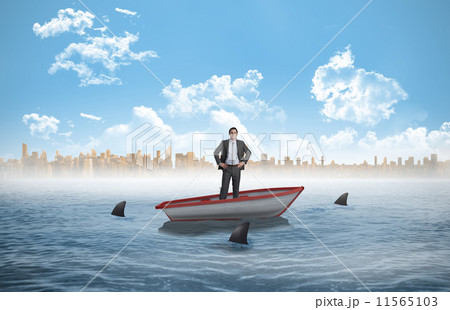 Composite image of businessman holding umbrella 11565103