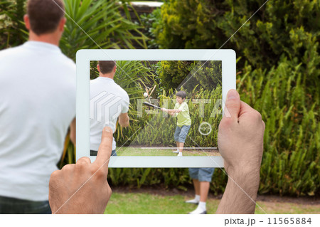 Composite image of hand holding tablet pc Composite image of hand holding tablet pc 11565884