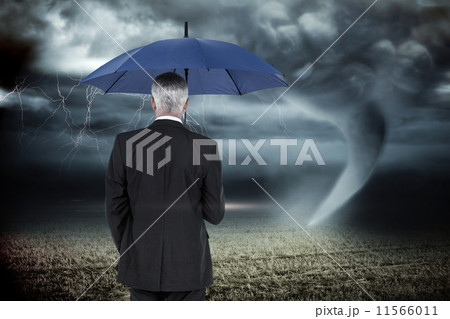 Composite image of happy businessman holding umbrella 11566011