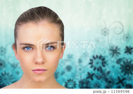 Composite image of annoyed brunette carrying large key Composite image of annoyed brunette carrying large key 11569596