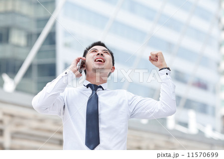 Asian business man speaking mobile phone 11570699