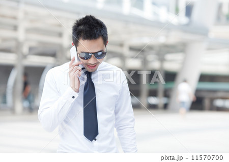Asian business man speaking mobile phone Asian business man speaking mobile phone 11570700