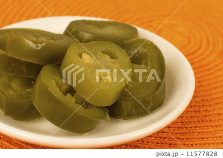 Jalapenos - Bowl of jalapeno chillies on an orange background	 11577828