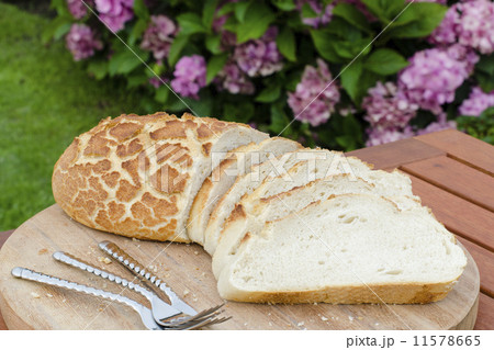 Tiger Bread - Crusty sliced white bread on a wooden board  11578665