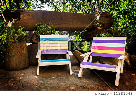 colorful wooden lawn chairs in the spring garden. 11581643