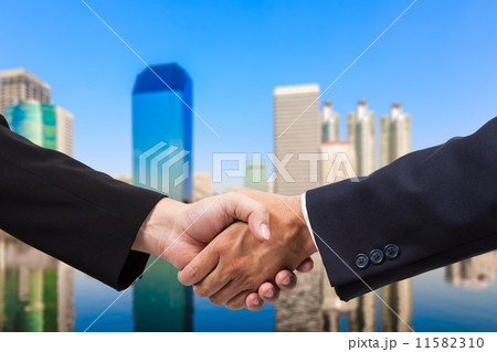 Businessman handshake with building background 11582310