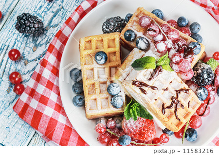 Waffles with fresh berries on the table Waffles with fresh berries on the table 11583216
