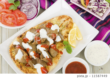 Donner Meat on Naan - Slices of donner meat on a flatbread  11587449