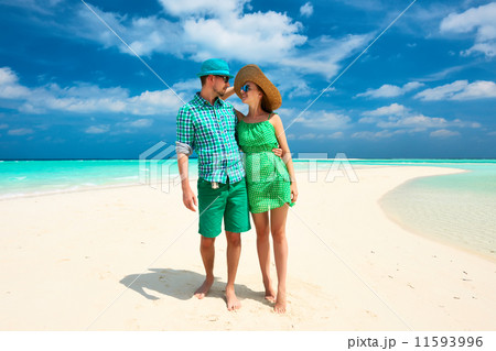 Couple in green on a beach at Maldives Couple in green on a beach at Maldives 11593996