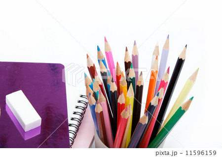 Coloured pencils and notebooks on a white background. 11596159