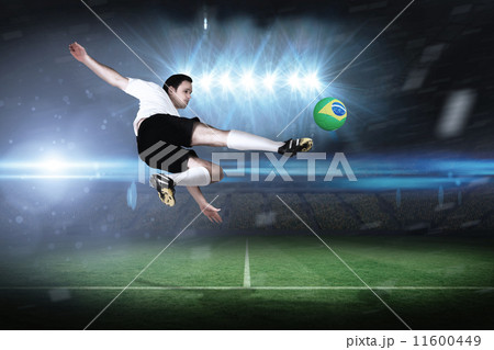 Composite image of football player in white kicking 11600449