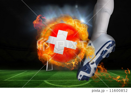 Football player kicking flaming swiss flag ball Football player kicking flaming swiss flag ball 11600852