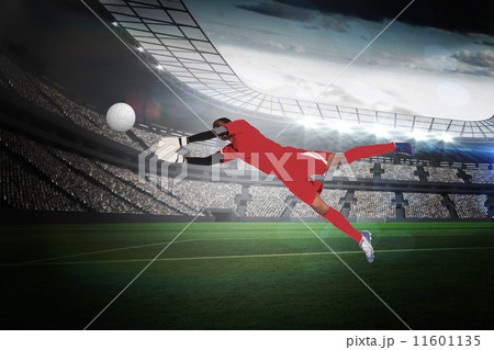 Composite image of goalkeeper in red making a save Composite image of goalkeeper in red making a save 11601135