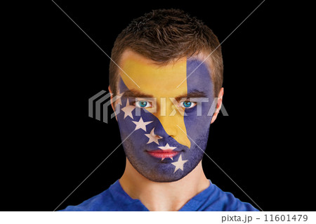 Composite image of serious young bosnian fan with facepaint Composite image of serious young bosnian fan with facepaint 11601479