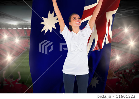 Composite image of excited football fan in white cheering holdin 11601522