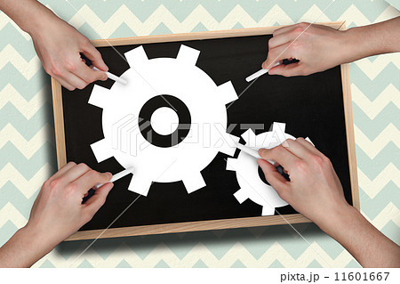 Composite image of multiple hands drawing cogs with chalk 11601667