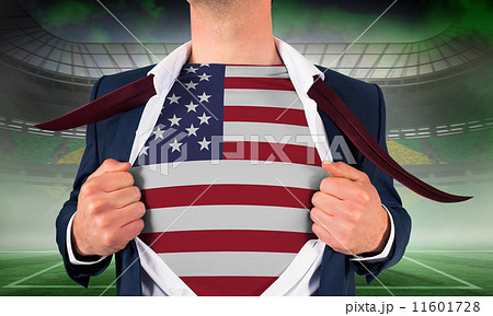 Composite image of businessman opening shirt to reveal usa flag 11601728