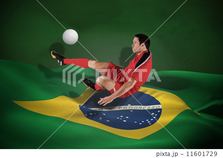 Composite image of football player in red kicking 11601729