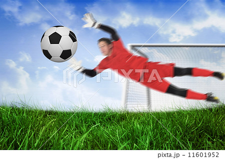 Composite image of fit goal keeper jumping up saving ball 11601952