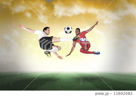 Composite image of football players tackling for the ball Composite image of football players tackling for the ball 11602082