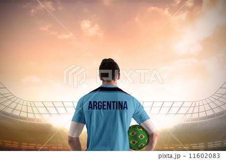 Composite image of argentina football player holding ball 11602083
