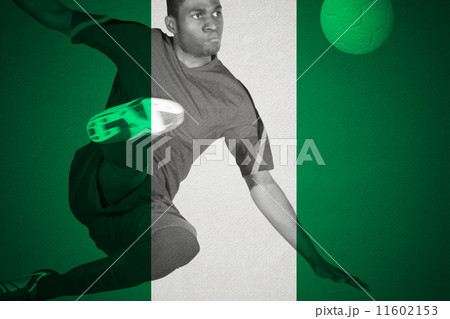 Composite image of football player in green kicking Composite image of football player in green kicking 11602153