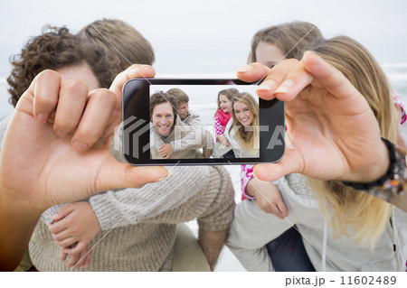 Composite image of hand holding smartphone showing Composite image of hand holding smartphone showing 11602489
