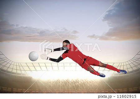 Composite image of goalkeeper in red making a save Composite image of goalkeeper in red making a save 11602915