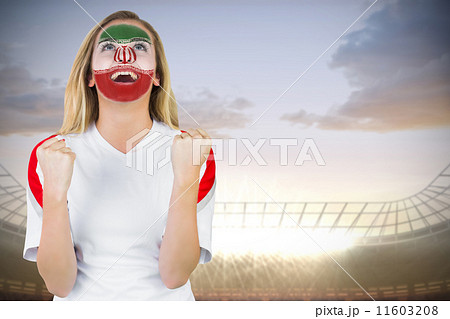 Composite image of excited iran fan in face paint cheering 11603208
