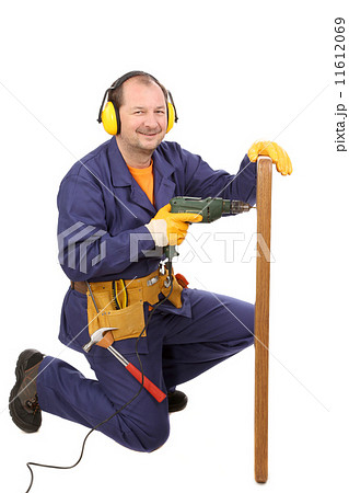 Worker in ear muffs with drill and board Worker in ear muffs with drill and board 11612069