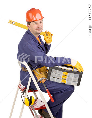 Worker on ladder with ruler and toolbox Worker on ladder with ruler and toolbox 11612257