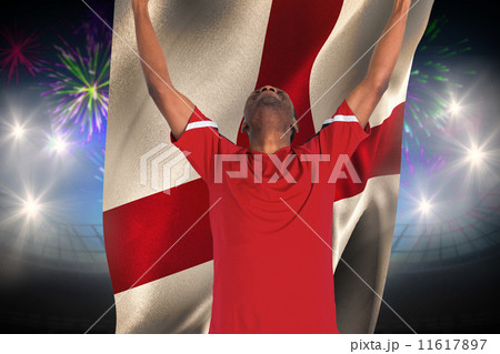 Composite image of excited handsome football fan cheering 11617897