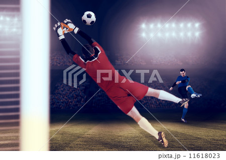 Composite image of goalkeeper in red jumping up 11618023