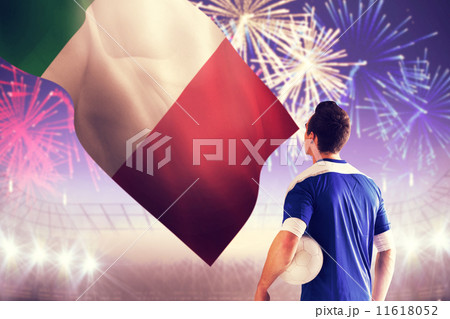 Composite image of italian handsome football player in blue jersey 11618052