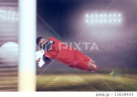 Composite image of goalkeeper in red making a save 11618433