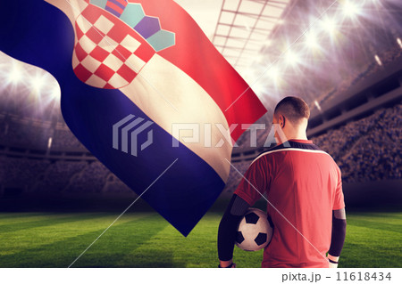 Composite image of goalkeeper in red holding the ball 11618434