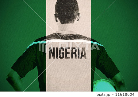 Composite image of nigeria football player holding ball Composite image of nigeria football player holding ball 11618604