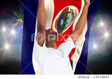 Composite image of excited handsome football fan cheering 11618645