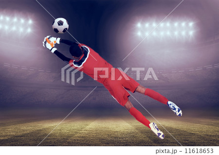 Composite image of goalkeeper in red making a save 11618653