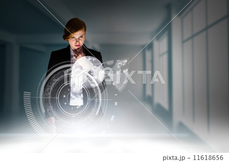 Composite image of redhead businesswoman using interactive desk 11618656